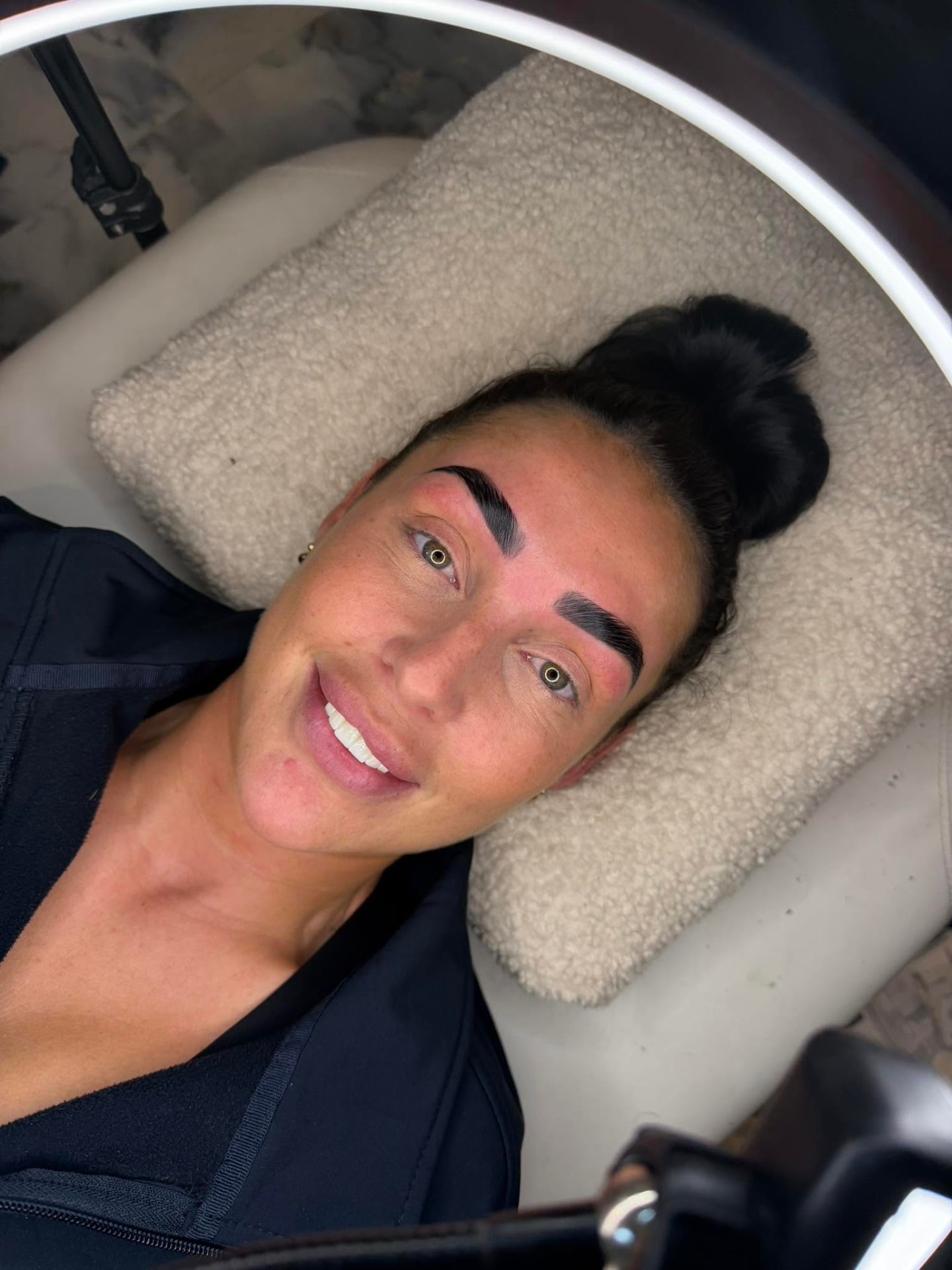 Client smiling after a brow lamination and tint appointment in Carlisle